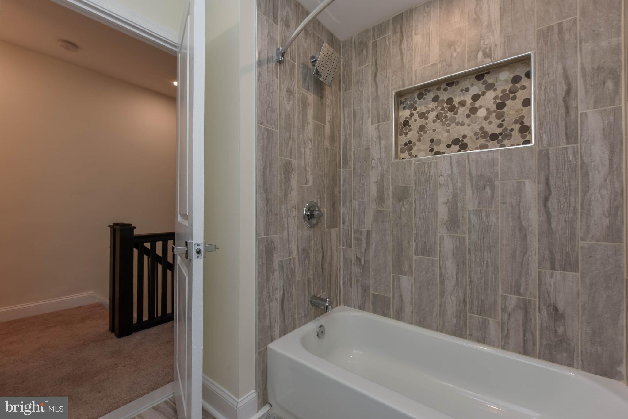 3108 Brighton Street Baltimore, MD 21216 - Photo 26 of 31 a bathroom with a bathtub and shower