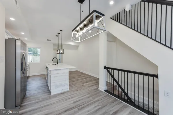 a kitchen with stainless steel appliances granite countertop a sink a refrigerator and a stove