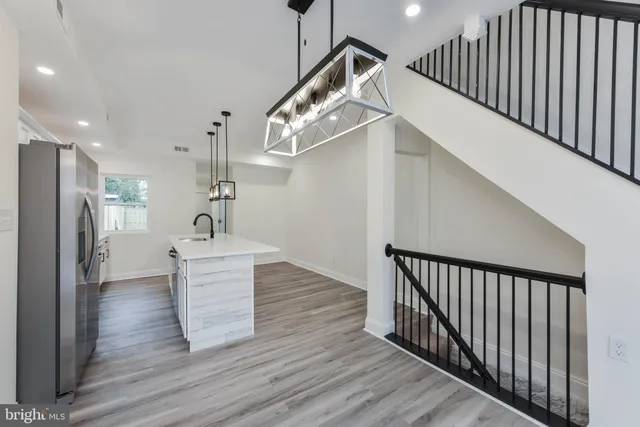 a kitchen with stainless steel appliances granite countertop a sink a refrigerator and a stove