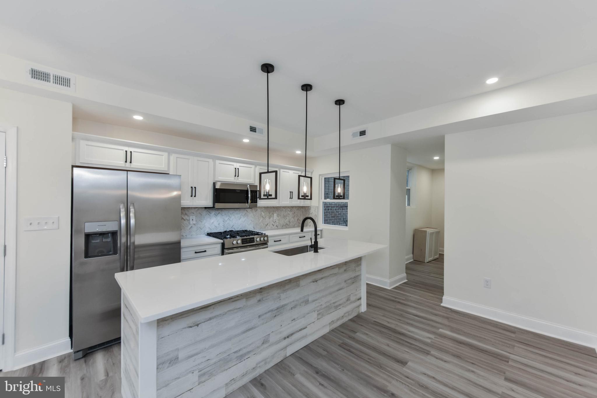 3108 Brighton Street Baltimore, MD 21216 - Photo 7 of 31 a kitchen with stainless steel appliances granite countertop a sink a refrigerator and a stove