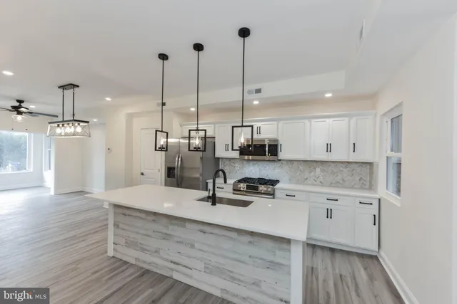 a living room with furniture wooden floor and a chandelier