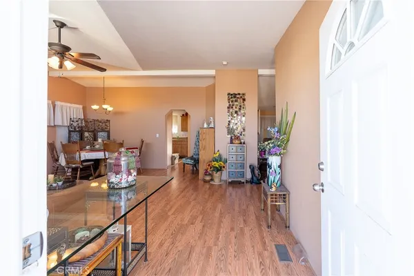 a living room with lots of furniture and a kitchen view