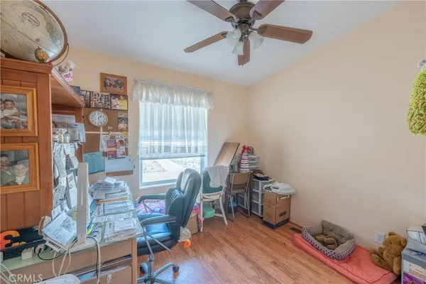 a bedroom with furniture and a wooden floor