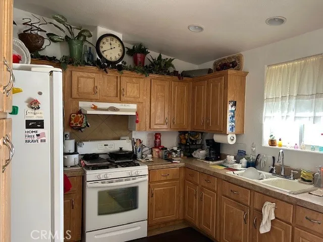 a kitchen with a sink cabinets and window