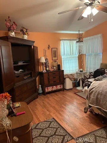 a living room with furniture a flat screen tv and a window