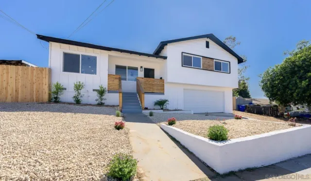 a view of a house with pool and sitting area