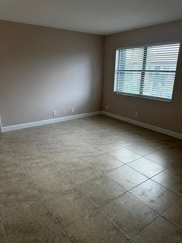 an empty room with a empty space and windows