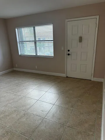 an empty room with a empty space and windows