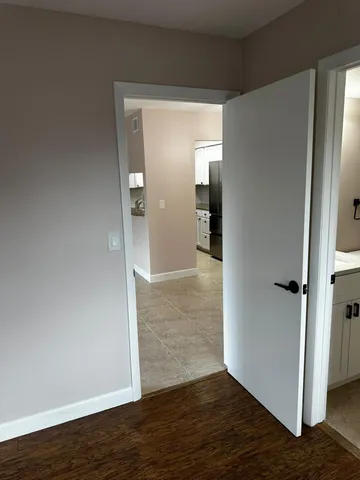 wooden floor in a hall with an empty room