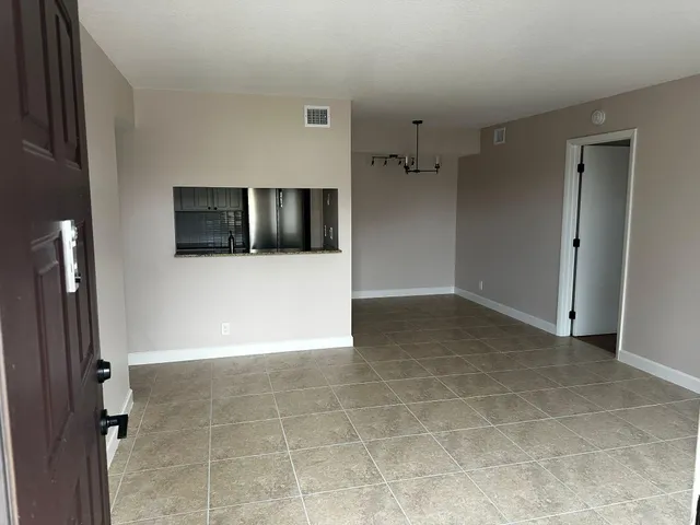 a view of a hallway with a refrigerator