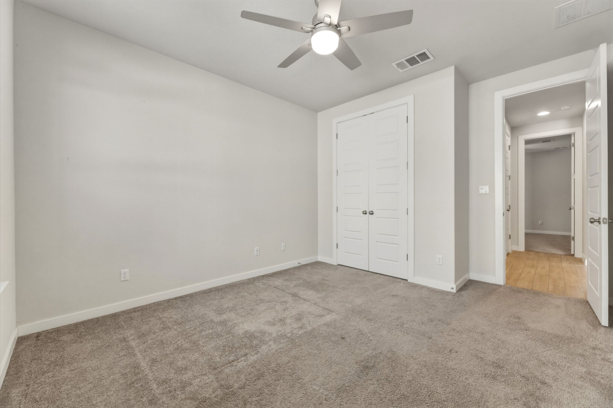 116 Tanali Trail Georgetown, TX 78628 - Photo 11 of 40 Unfurnished bedroom featuring light colored carpet, ceiling fan, and a closet