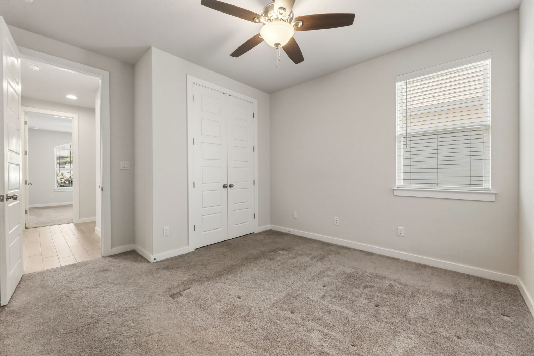 116 Tanali Trail Georgetown, TX 78628 - Photo 12 of 40 Unfurnished bedroom with light colored carpet, a ceiling fan, and a closet