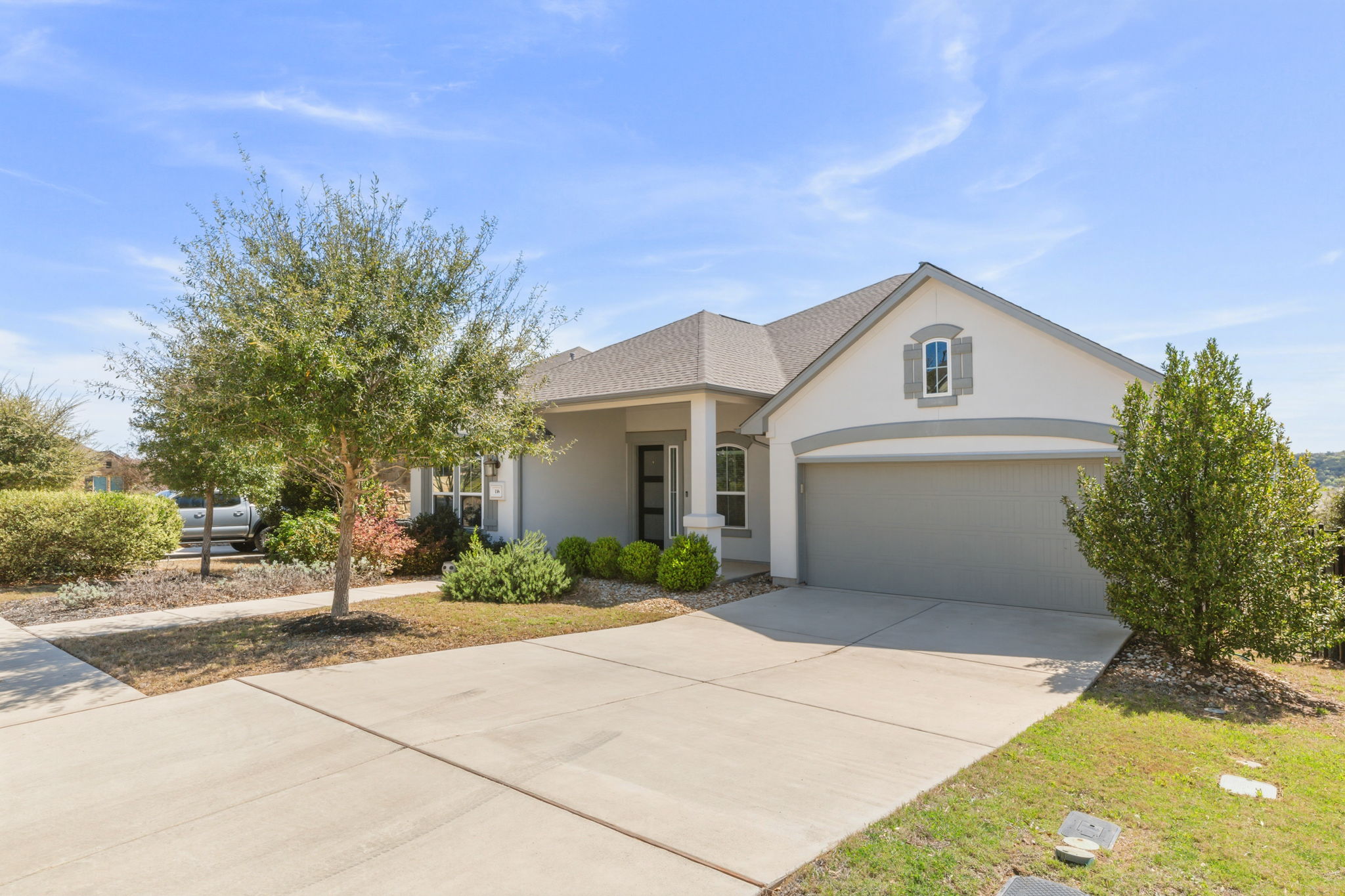 116 Tanali Trail Georgetown, TX 78628 - Photo 2 of 40 View of front of home with driveway, stucco siding, an attached garage, and a shingled roof
