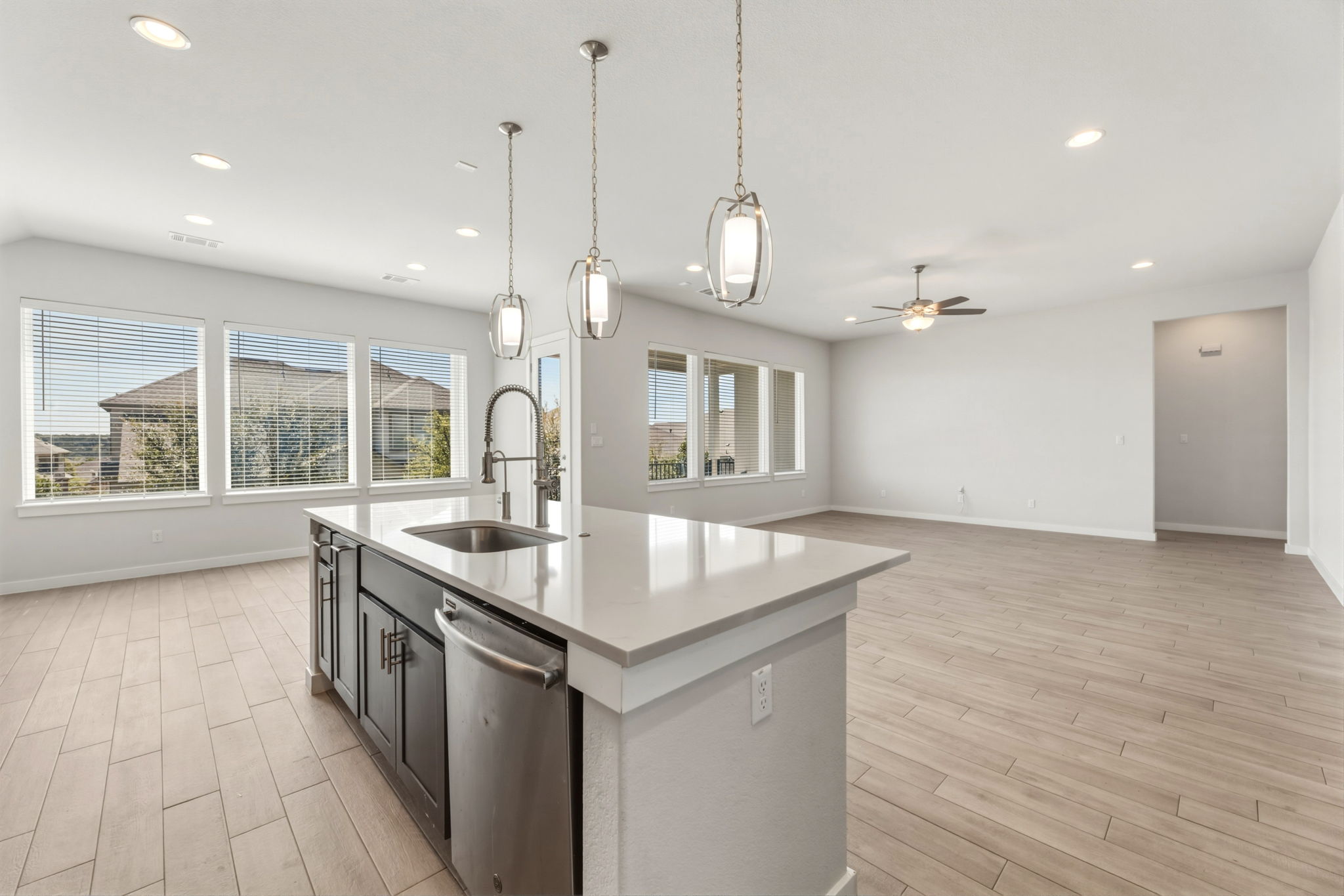 116 Tanali Trail Georgetown, TX 78628 - Photo 39 of 40 Kitchen featuring an island with sink, wood tiled floors, open floor plan, and dishwasher