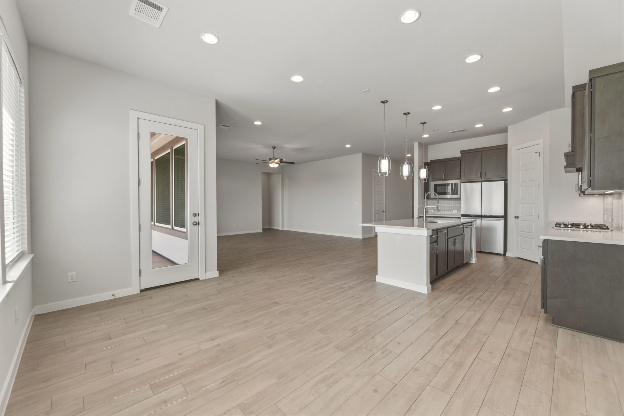 116 Tanali Trail Georgetown, TX 78628 - Photo 40 of 40 Kitchen featuring open floor plan, a ceiling fan, stainless steel appliances, pendant lighting, and a center island with sink