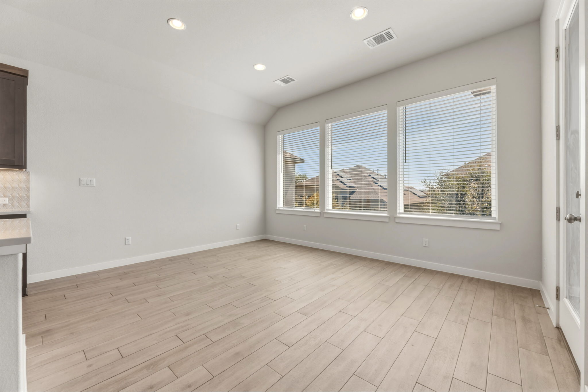 116 Tanali Trail Georgetown, TX 78628 - Photo 22 of 40 Unfurnished dining area featuring recessed lighting, wood tiled floors, and vaulted ceiling
