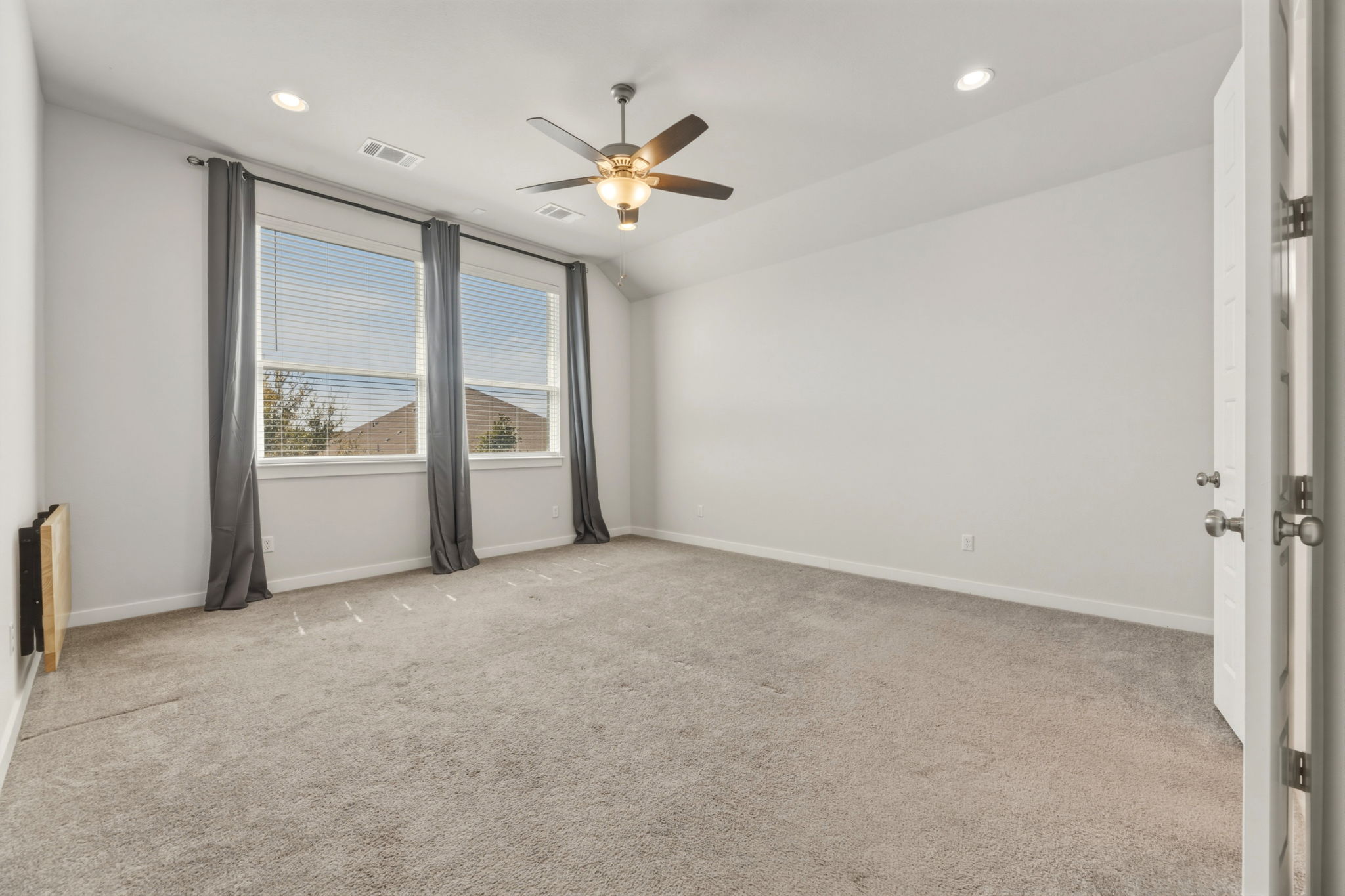 116 Tanali Trail Georgetown, TX 78628 - Photo 27 of 40 Empty room featuring light colored carpet, a ceiling fan, recessed lighting, and lofted ceiling