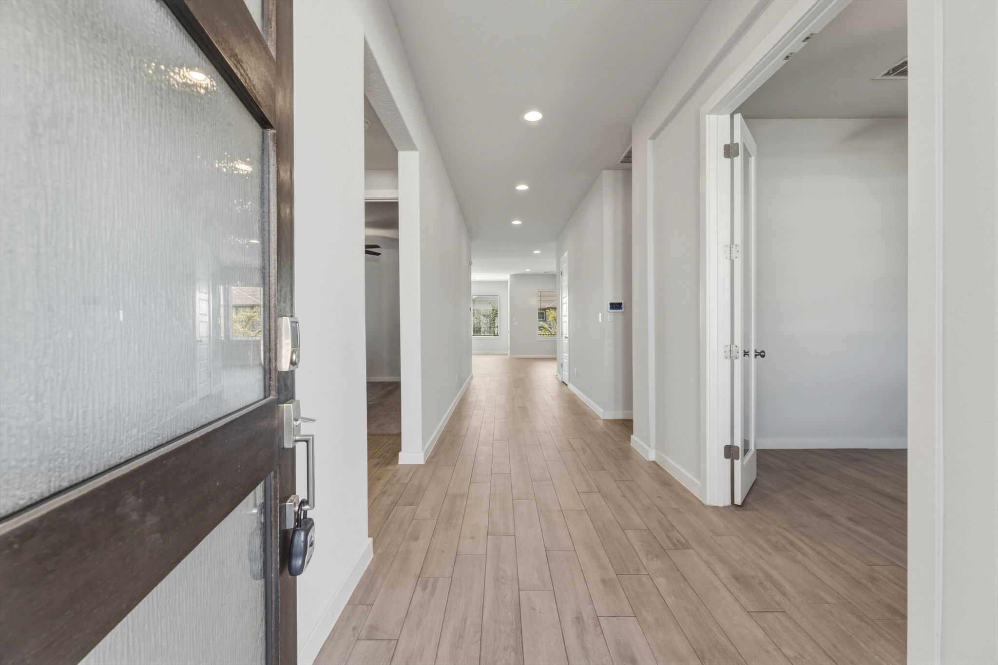 116 Tanali Trail Georgetown, TX 78628 - Photo 4 of 40 Corridor with recessed lighting and light wood-type flooring