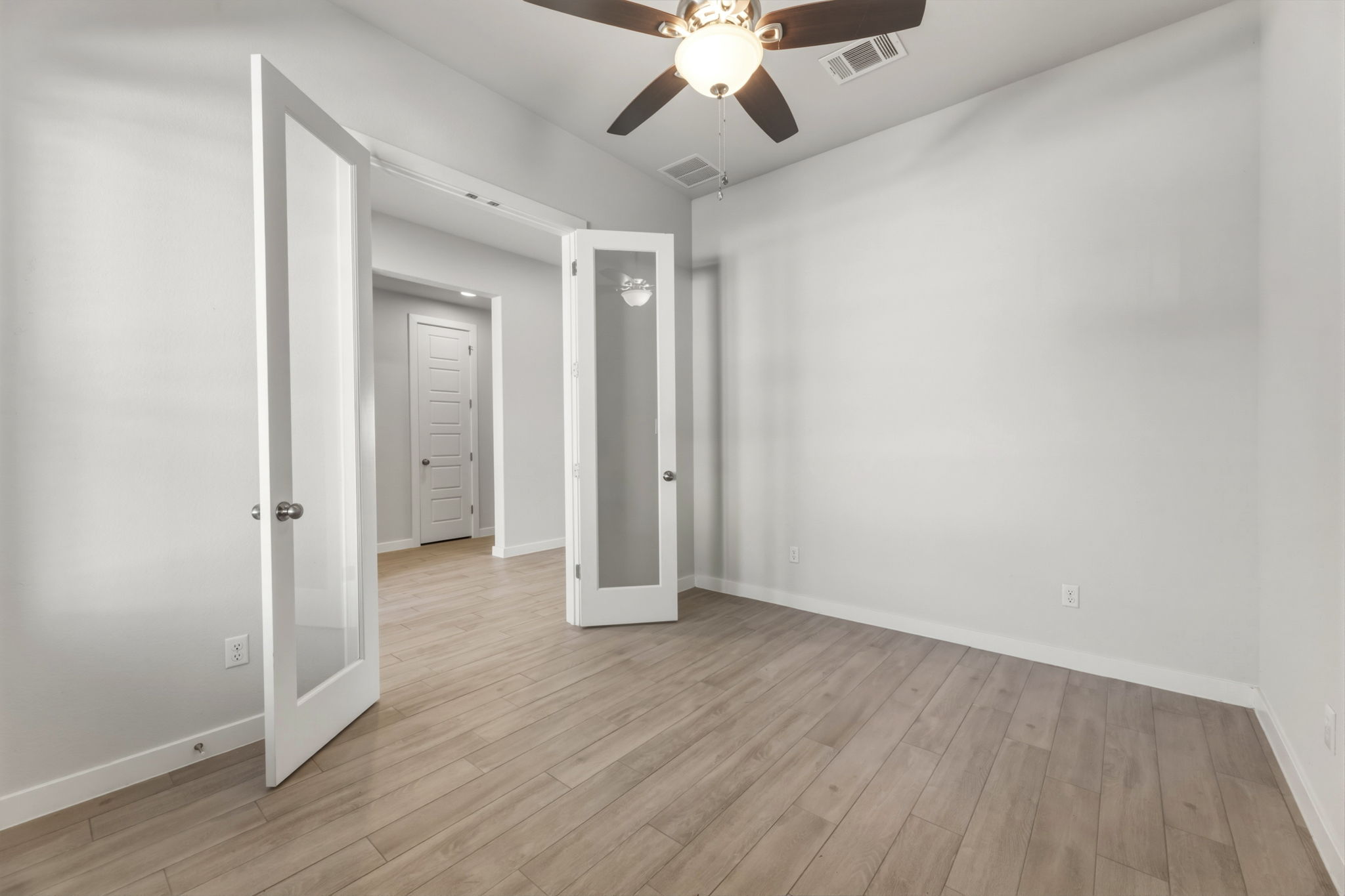 116 Tanali Trail Georgetown, TX 78628 - Photo 7 of 40 Unfurnished bedroom featuring a ceiling fan and light wood-style flooring