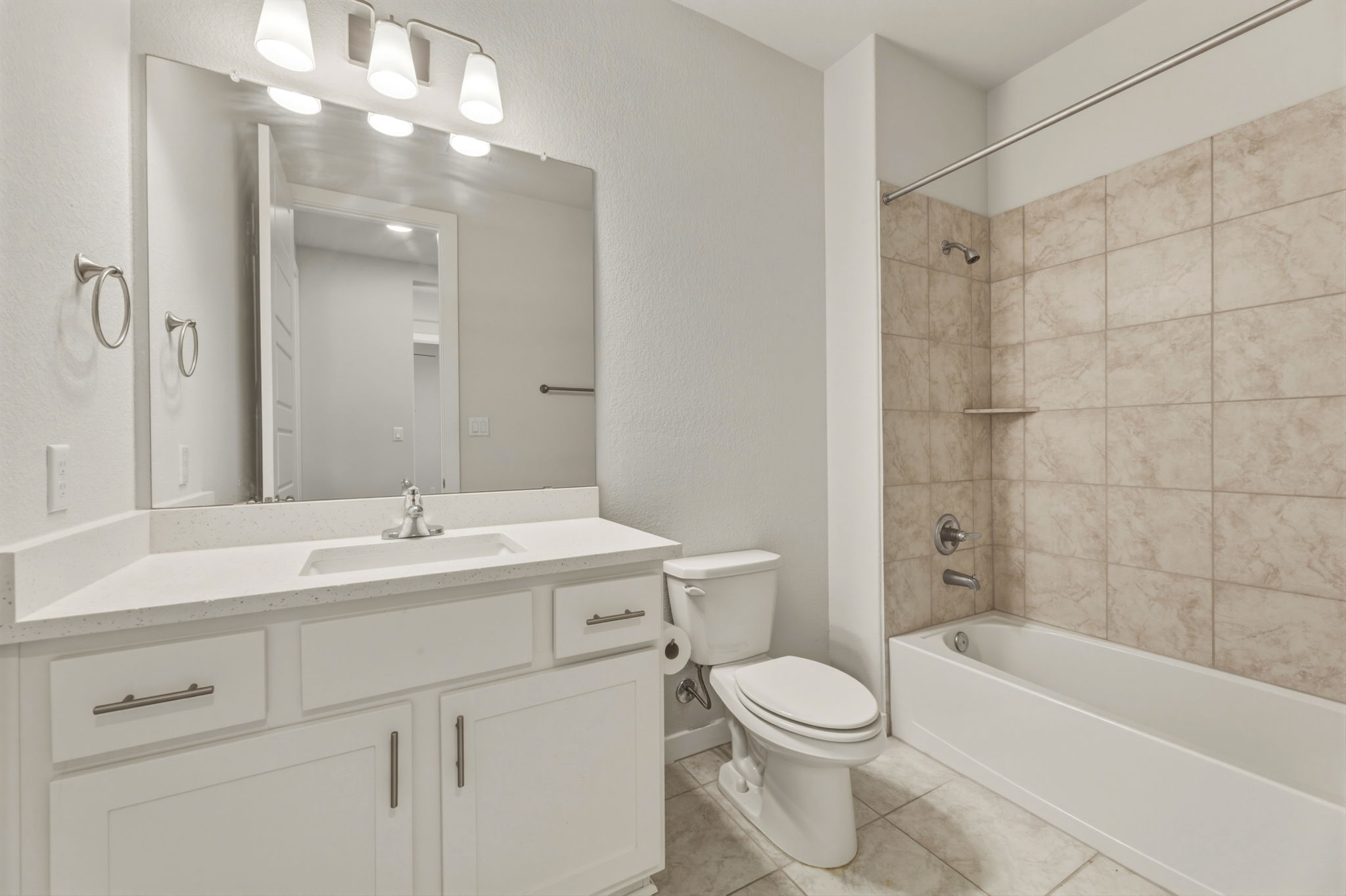 116 Tanali Trail Georgetown, TX 78628 - Photo 9 of 40 Full bath featuring vanity, shower / tub combination, light tile patterned flooring, and a textured wall