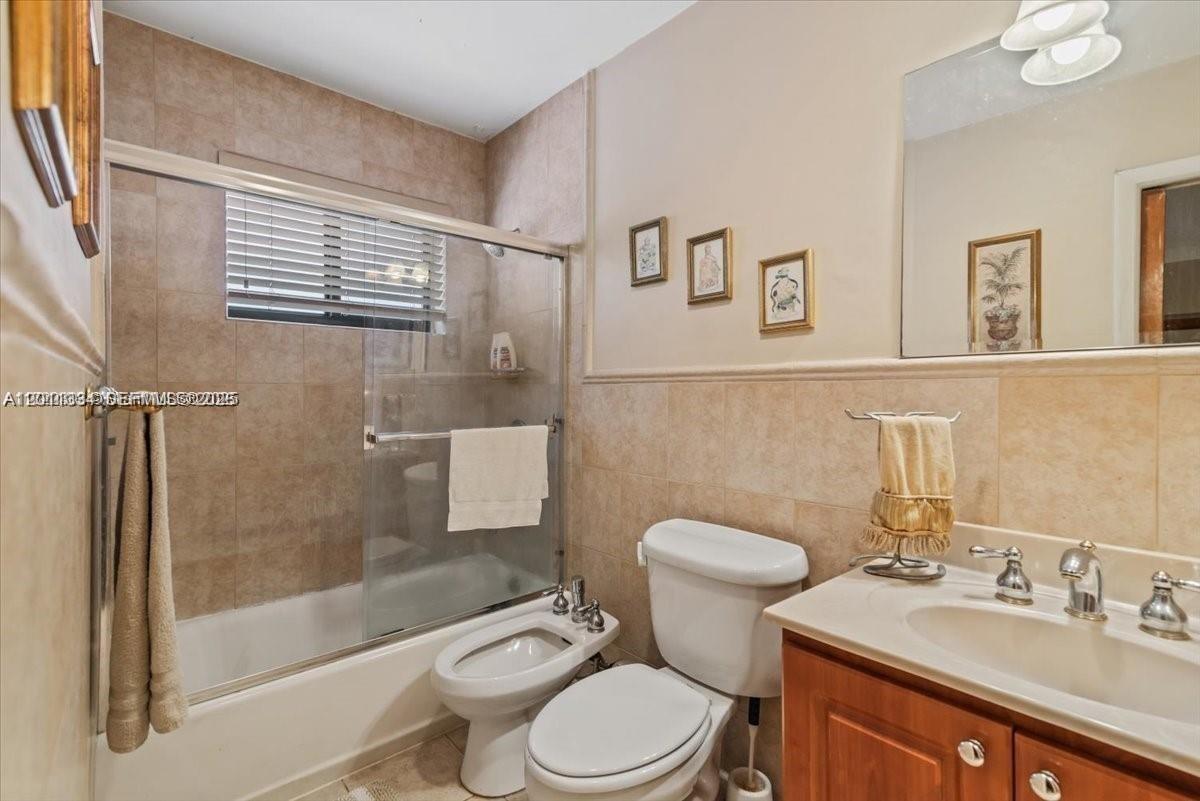 6385 Southwest 25th Street Miami, FL 33155 - Photo 17 of 28 a bathroom with a sink a toilet and shower