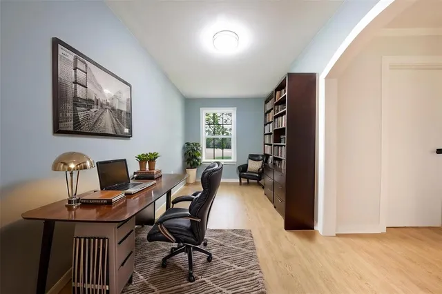 a view of a workspace with furniture and a window