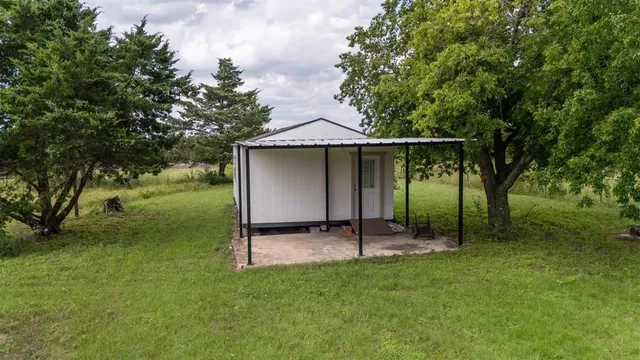 a backyard of a house with barbeque oven