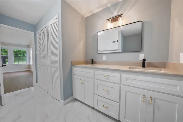 a bathroom with a double vanity sink and mirror