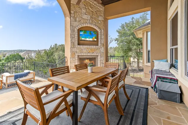 a view of a patio with table and chairs and potted plants