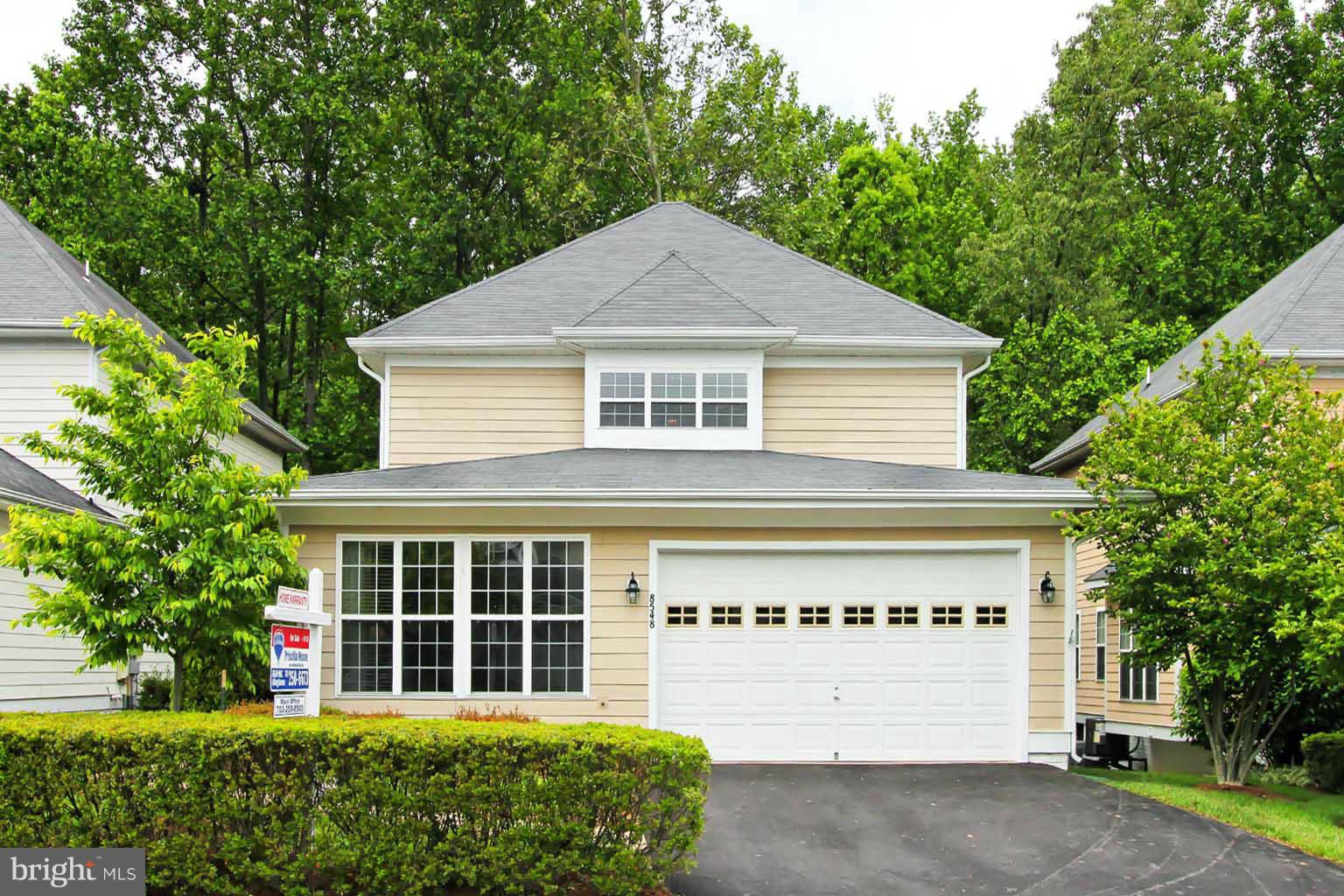 8548 Bauer Circle Springfield, VA 22152 - Photo 1 of 30 a front view of a house with a garden