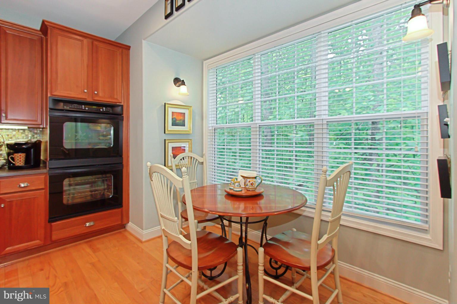 8548 Bauer Circle Springfield, VA 22152 - Photo 13 of 30 a dining room with furniture and a fireplace