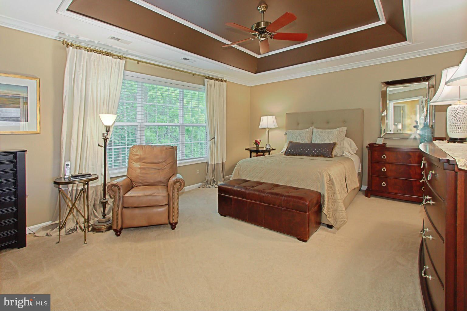 8548 Bauer Circle Springfield, VA 22152 - Photo 20 of 30 a bedroom with a bed couch chandelier and a window