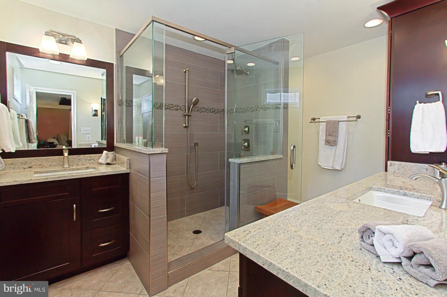 8548 Bauer Circle Springfield, VA 22152 - Photo 22 of 30 a bathroom with a granite countertop sink mirror and shower