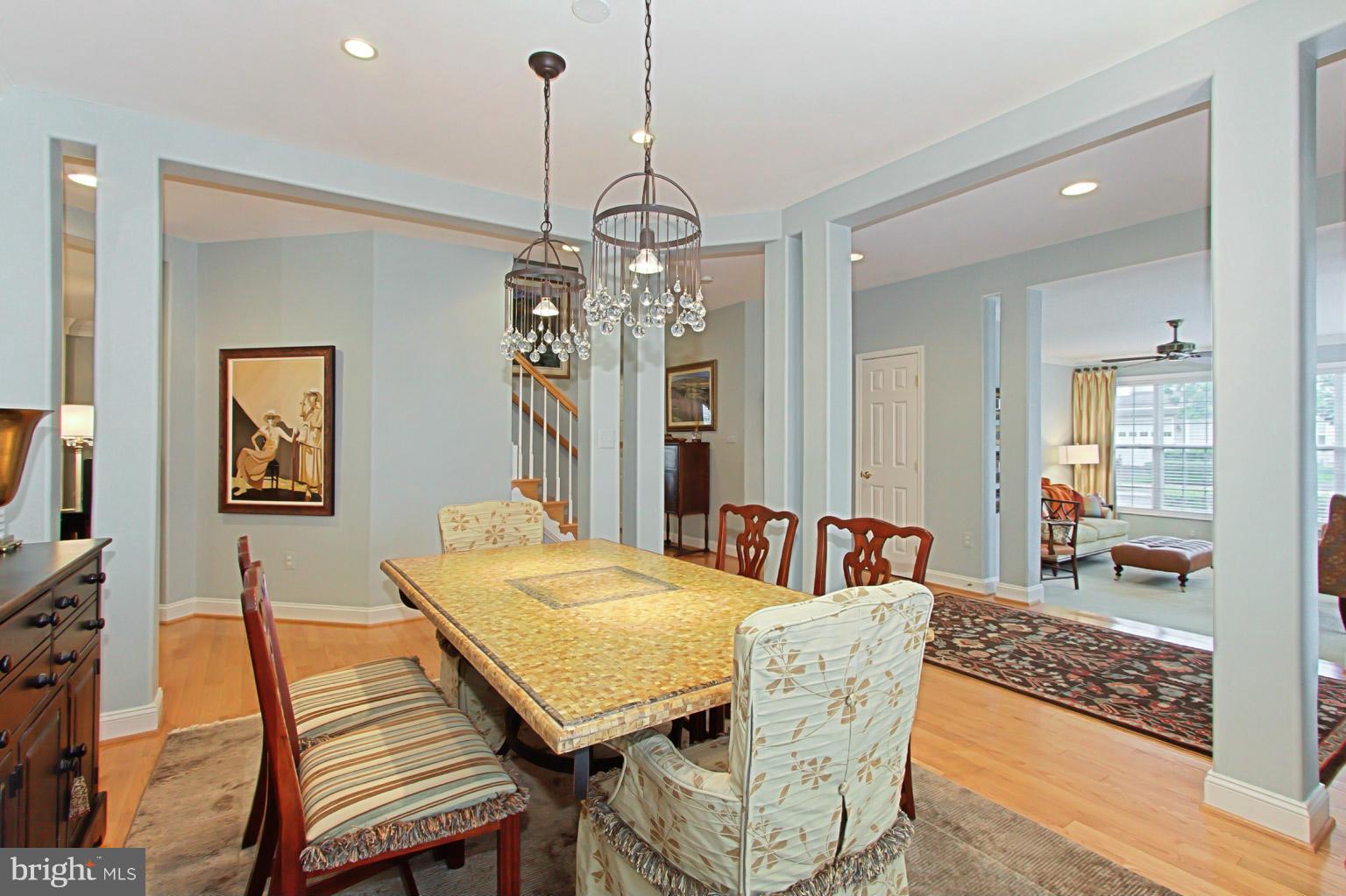 8548 Bauer Circle Springfield, VA 22152 - Photo 9 of 30 a dining room with furniture a chandelier and wooden floor