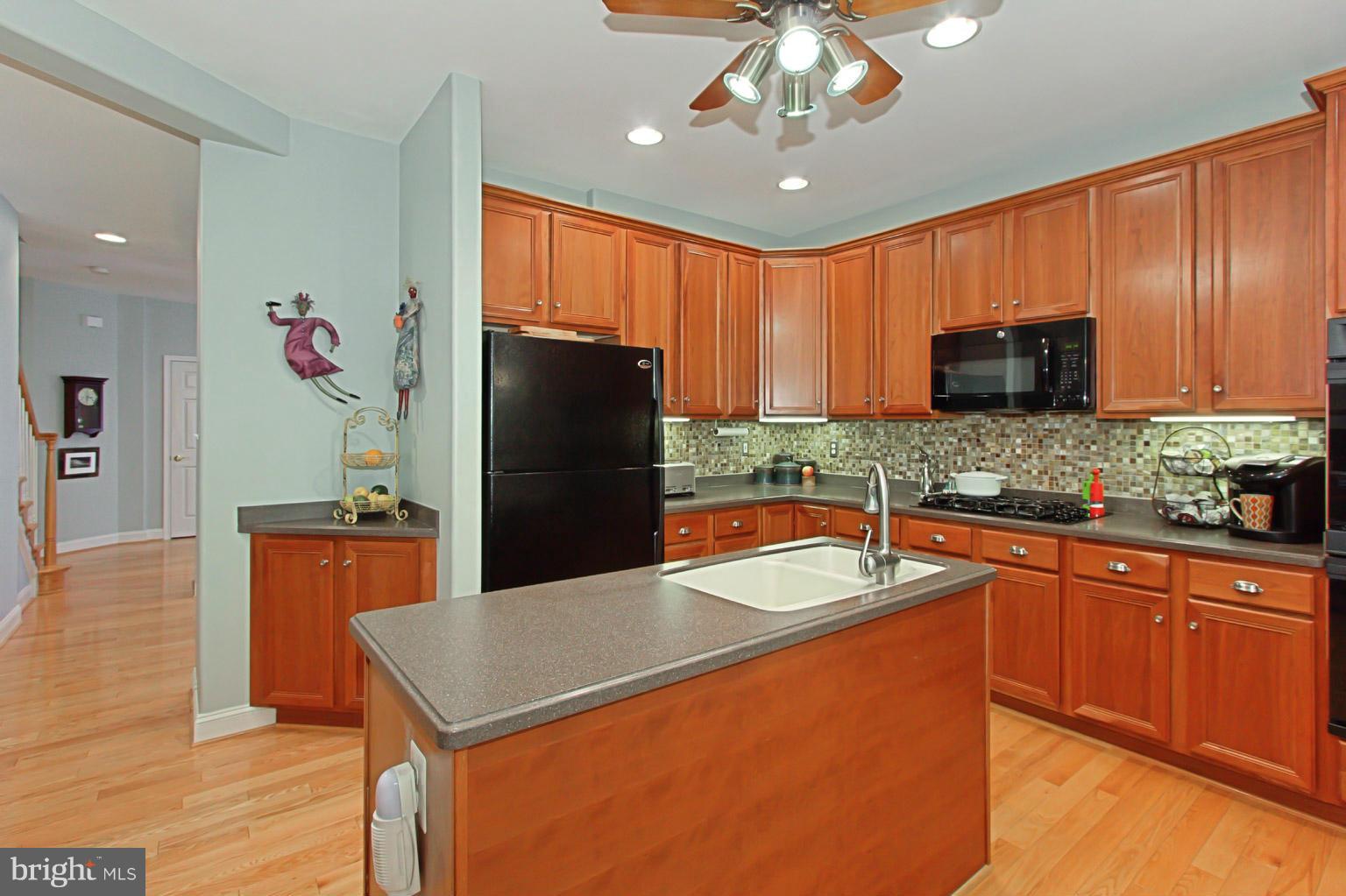 8548 Bauer Circle Springfield, VA 22152 - Photo 10 of 30 a kitchen with stainless steel appliances granite countertop a refrigerator a sink dishwasher with a stove and refrigerator