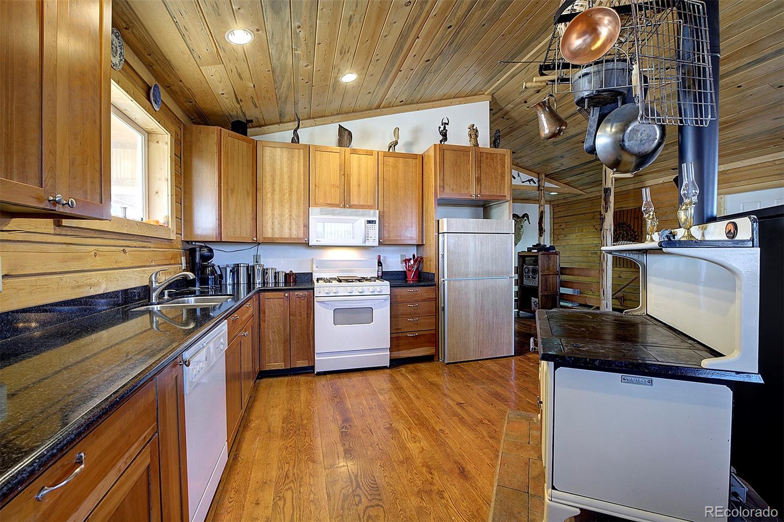 2005 Cahokia Road Hartsel, CO 80449 - Photo 21 of 42 a kitchen with cabinets and wooden floor