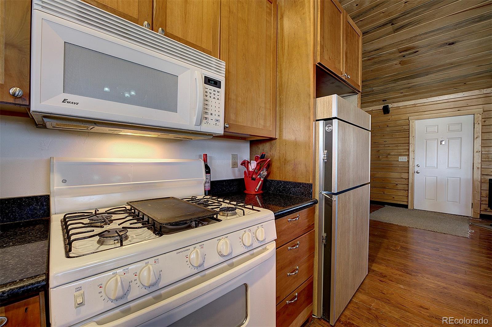 2005 Cahokia Road Hartsel, CO 80449 - Photo 22 of 42 a kitchen with a refrigerator a stove and cabinets