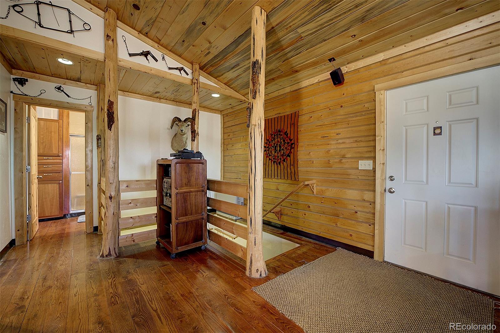 2005 Cahokia Road Hartsel, CO 80449 - Photo 24 of 42 a view of a hallway with wooden floor and staircase