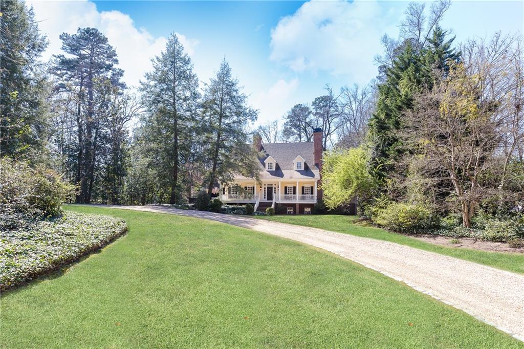 private, pristine 1.4 acres with 181 feet of street frontage sits low-country style home behind iconic hemlocks