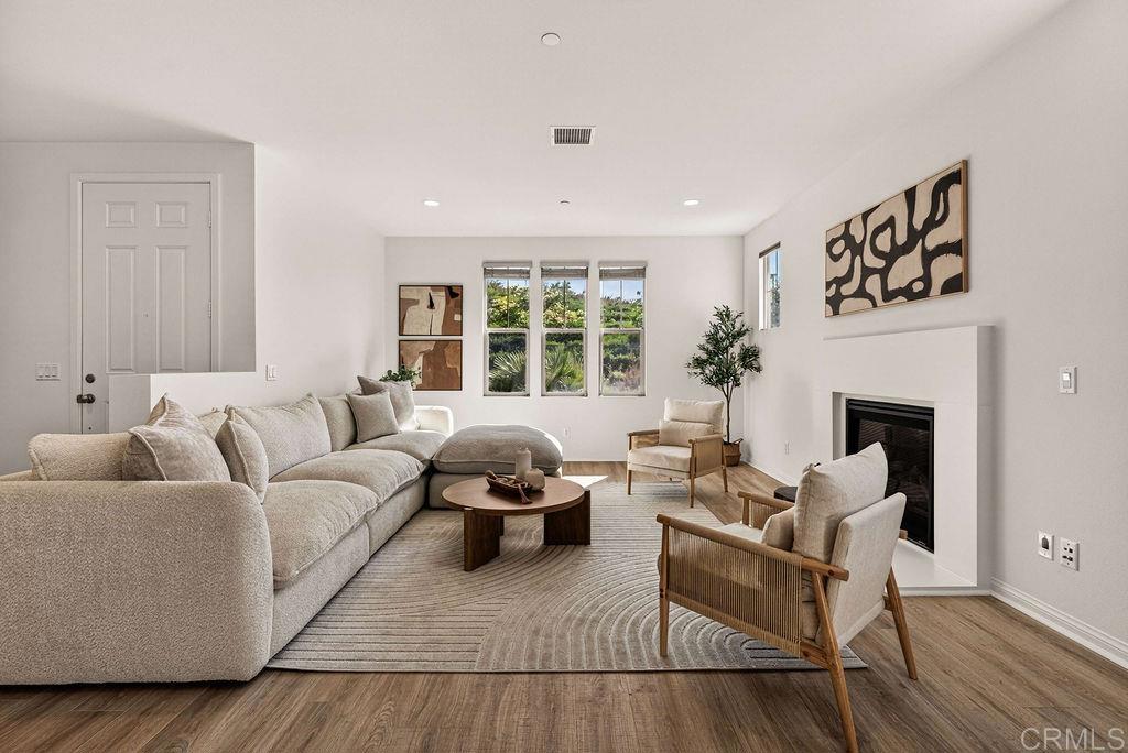 4301 Pacifica Way, Unit 2 Oceanside, CA 92056 - Photo 2 of 47 a living room with furniture fireplace and a large window
