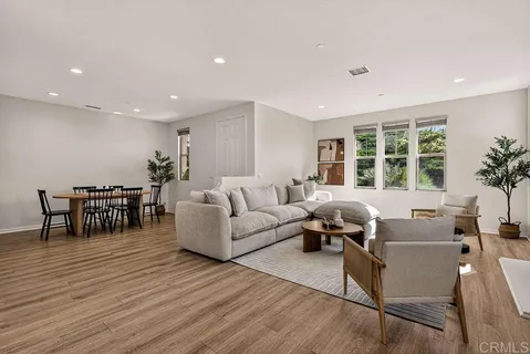 a living room with furniture and large windows