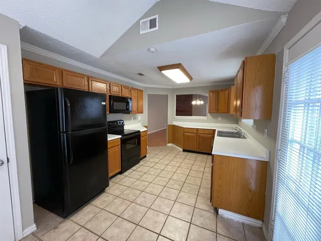 a kitchen with stainless steel appliances a refrigerator and a sink