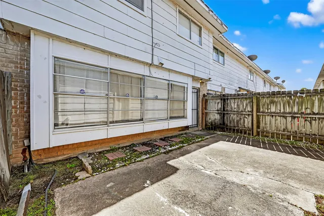 a view of a house with a wooden fence