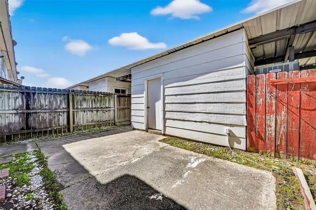 a view of a backyard with wooden fence