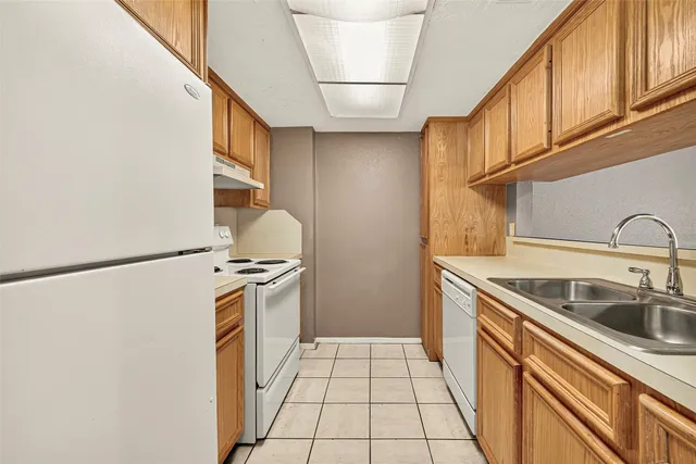 a kitchen with a sink and a refrigerator