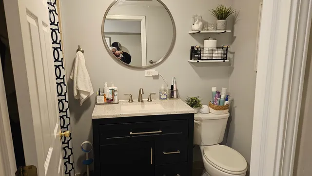 a bathroom with a toilet a sink and a mirror