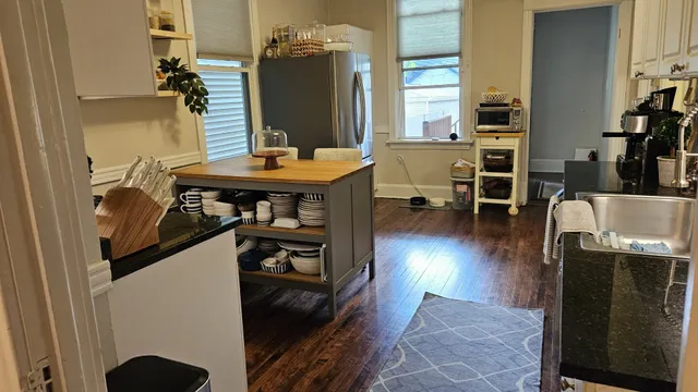 a view of a living room with furniture and a flat screen tv