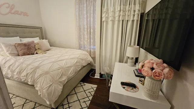 a bedroom with a bed and a window