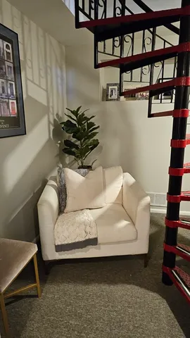 a living room with furniture and a book shelf
