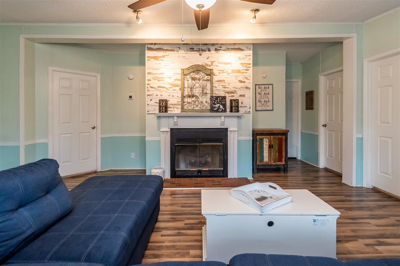 8409 Creek Road Willow Spring, NC 27592 - Photo 7 of 27 a living room with furniture and a fireplace